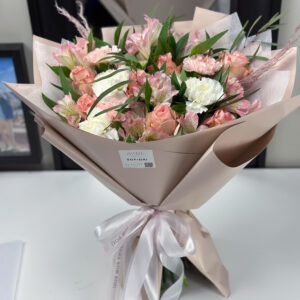 Elegant Sofiori Bouquet: A lush and vibrant floral arrangement featuring a mix of pink roses, white carnations, and greenery, wrapped in a soft gray paper and tied with a delicate ribbon.